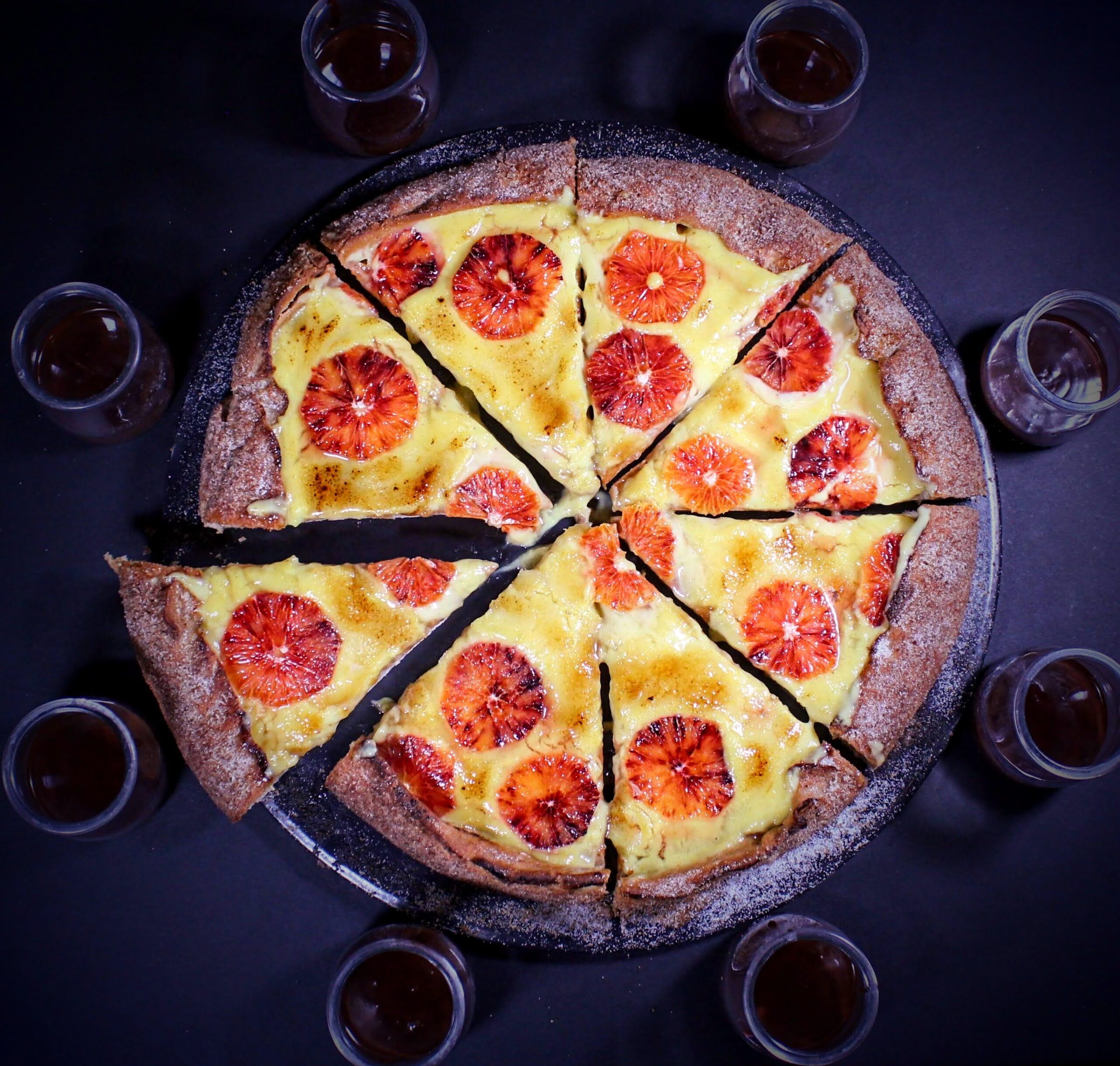 creme brule pizza on dark background overhead